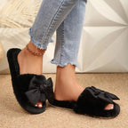 Women's faux leather bow open toe flat slippers by Trendsi, stylish slip-on shoes with a decorative bow detail.