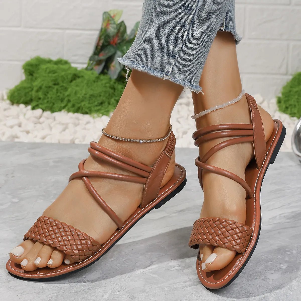 Brown braided ankle strap flat sandals made of comfortable PU leather, perfect for casual summer wear.