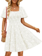 Women's smocked tiered square neck short sleeve casual dress with pockets by Trendsi, featuring a flowy silhouette and stylish design.