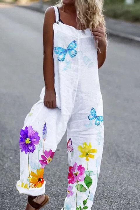 White linen-blend overalls featuring a colorful floral and blue butterfly print. Casual, wide-leg loose fit.
