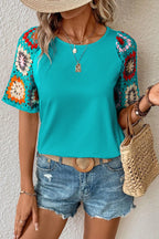 Geometric print round neck short sleeve blouse by Trendsi, stylish tops with modern design, displayed on a hanger.