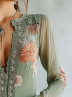 Elegant floral lace blouse by Trendsi featuring long sleeves and sophisticated feminine design, shown in a detailed close-up.