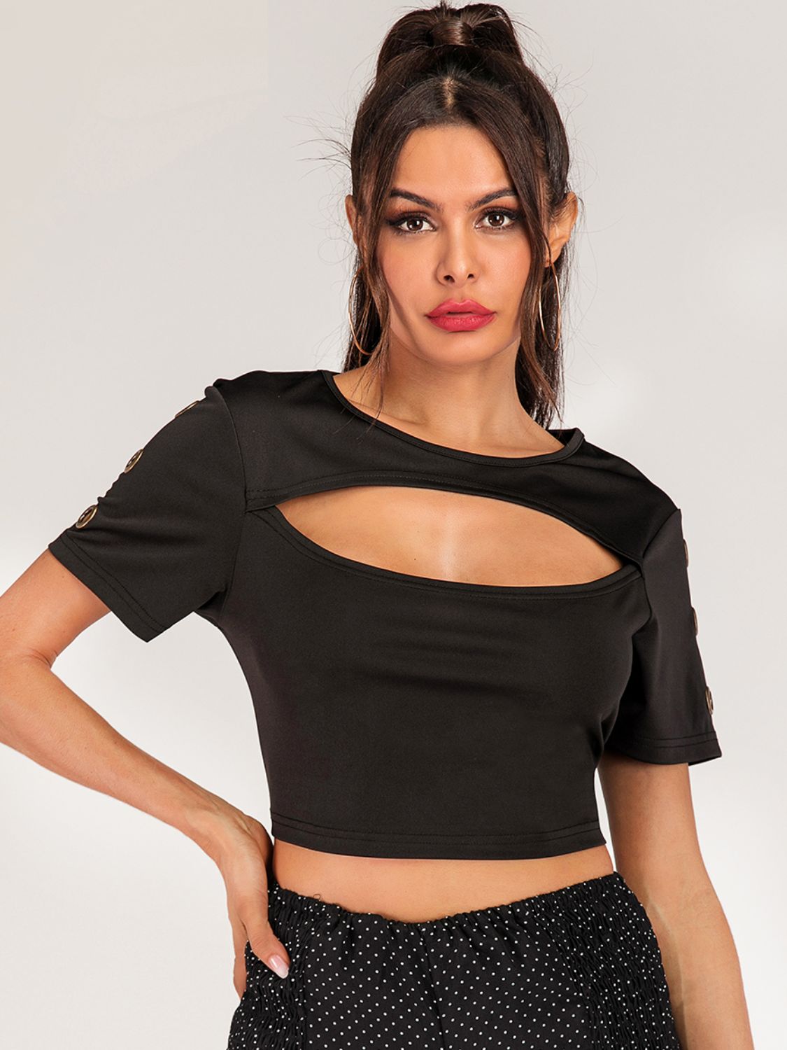 Women's cropped tee with grommet cutout details, short sleeves, trendy edgy fashion top from Trendsi.