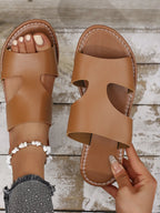 Women's chic vegan leather flat sandals with cutout design and open toe, offering stylish comfort from Trendsi.