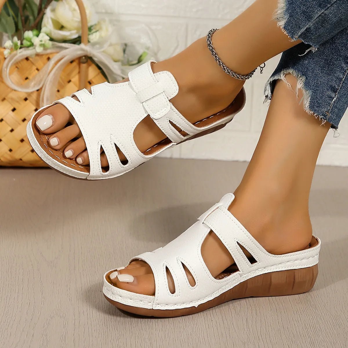 Women's chic cutout faux leather open-toe wedge sandals with ankle straps and stylish design.