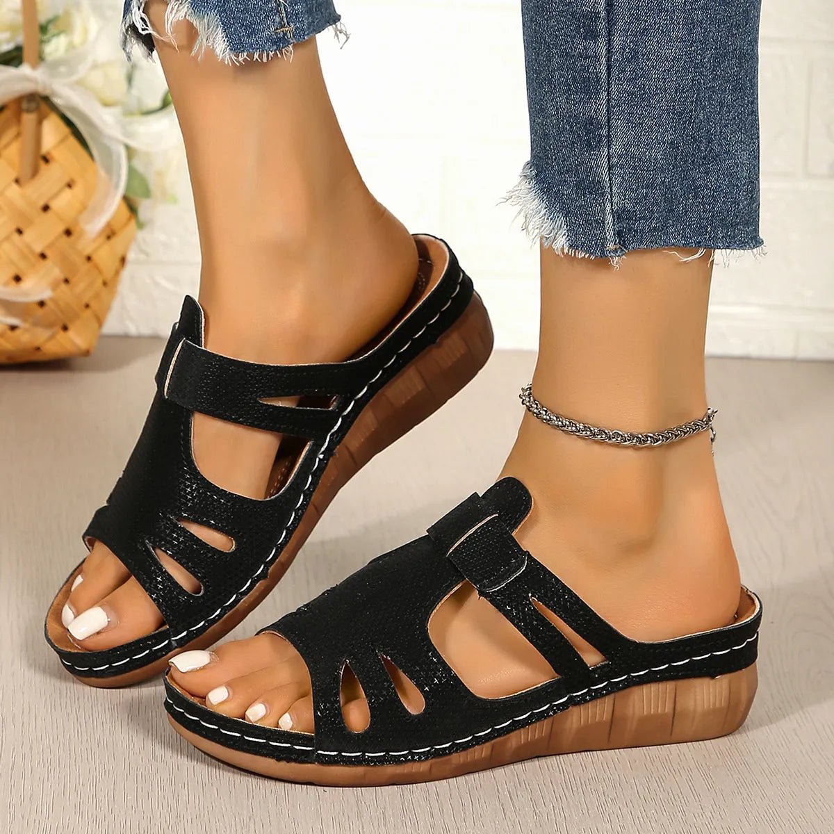 Women's chic faux leather open-toe wedge sandals with stylish cutouts and a trendy open-toe design.