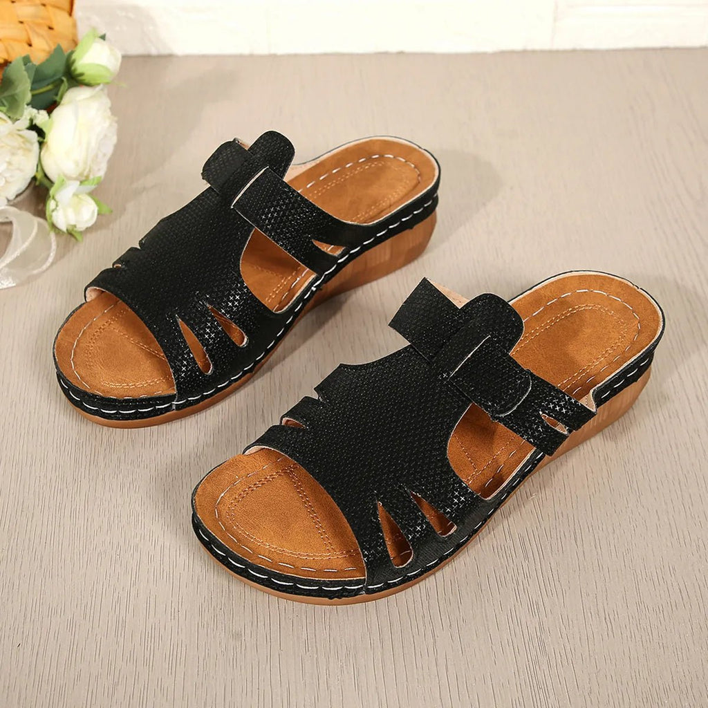 Women's chic cutout faux leather open-toe wedge sandals with stylish design and comfortable heel, perfect for casual or dressy occasions.