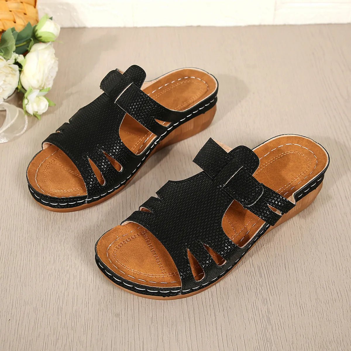 Women's chic cutout faux leather open-toe wedge sandals with stylish design and comfortable heel, perfect for casual or dressy occasions.