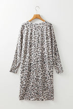 Leopard print V-neck long sleeve dress from Trendsi, stylish and fitted with a flowing skirt, perfect for casual or semi-formal wear.