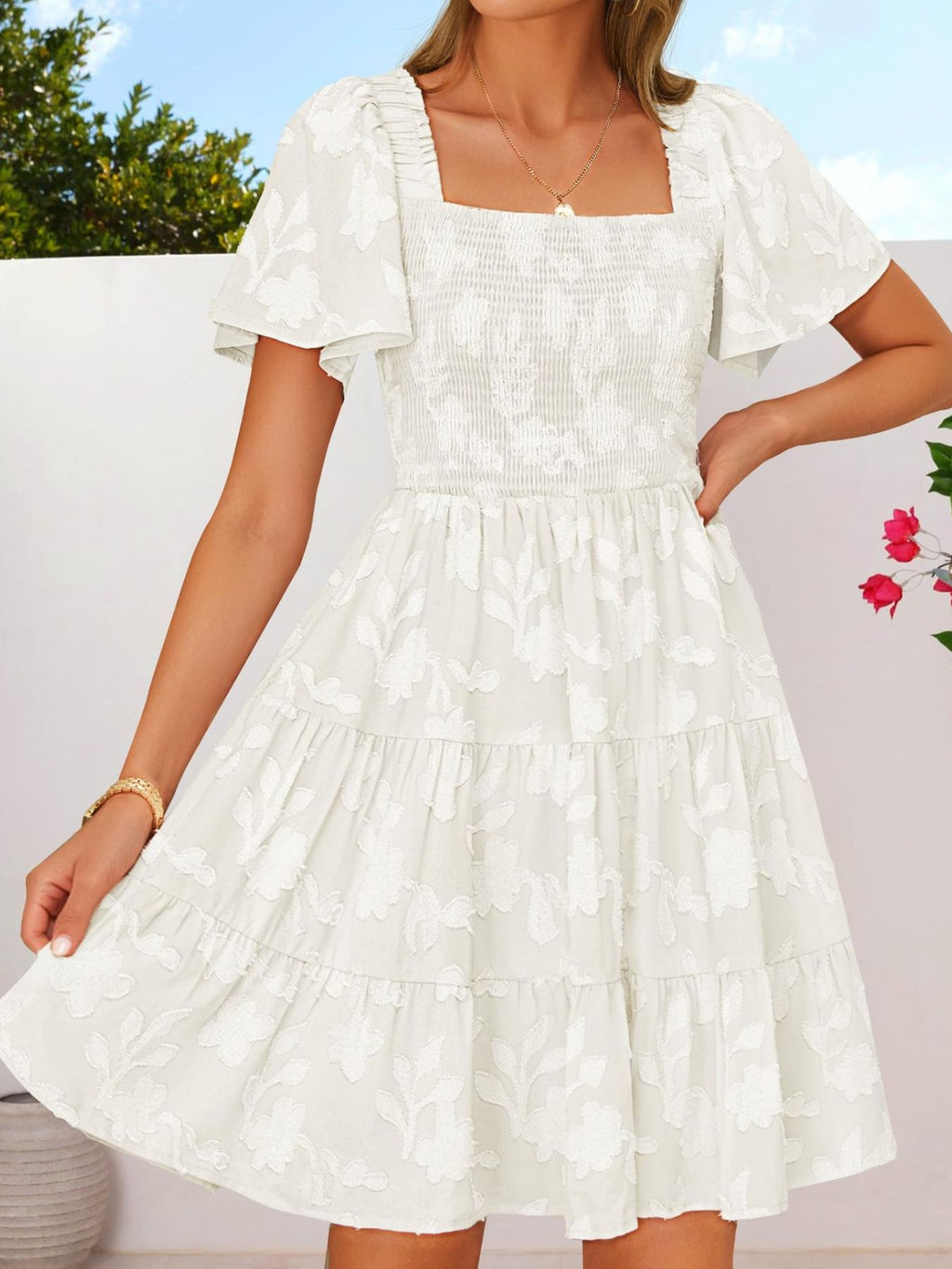 Women's smocked tiered square neck casual dress with short sleeves and pockets, by Trendsi, shown in a lightweight fabric.