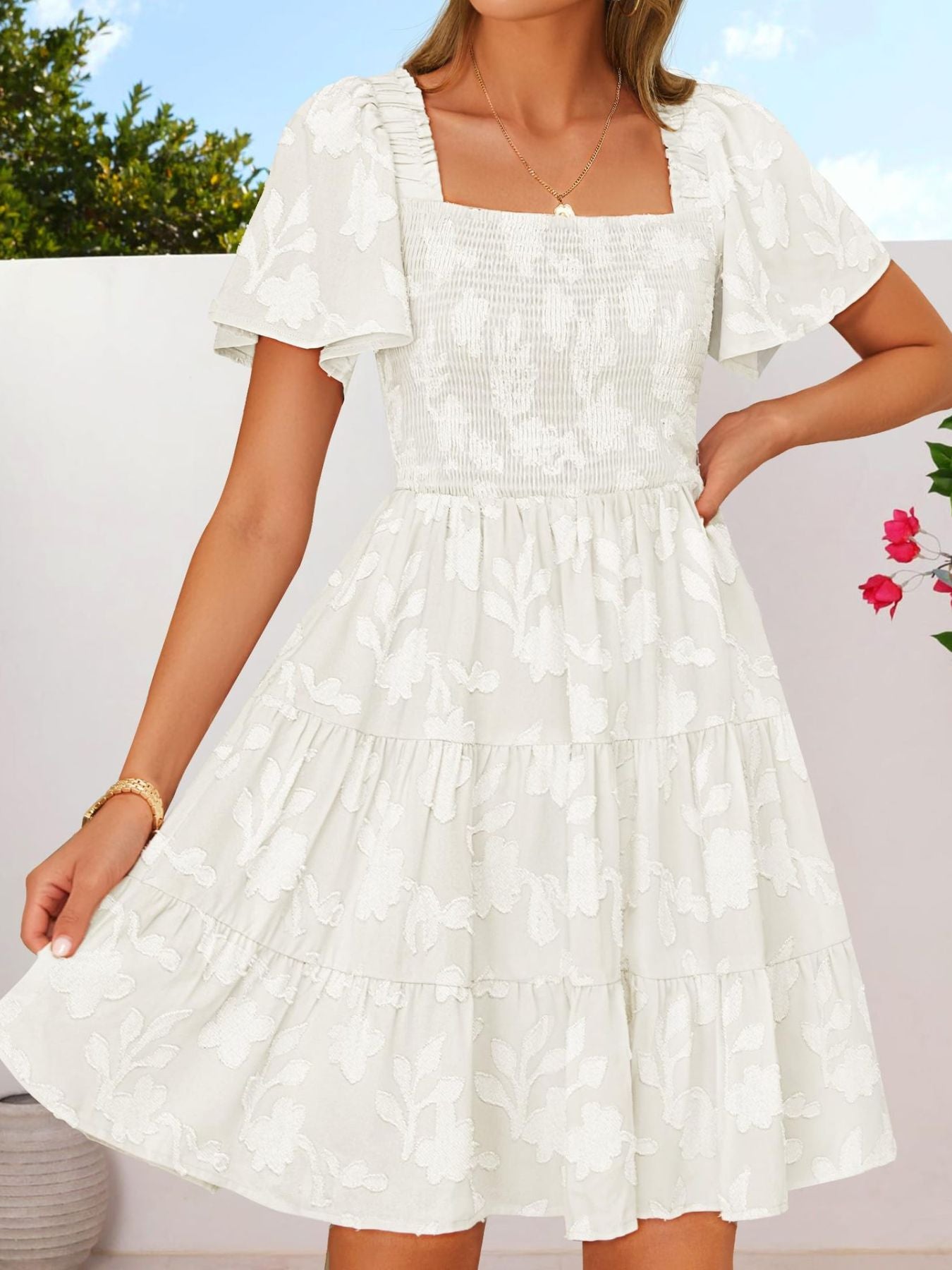Women's smocked tiered square neck casual dress with short sleeves and pockets, by Trendsi, shown in a lightweight fabric.