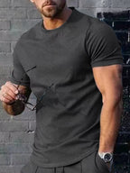 Men's plus size solid color casual T-shirt by Trendsi, shown in a relaxed fit with short sleeves on a plain background.
