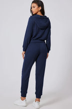 Women's half-zip drawstring hoodie and jogger lounge set, trendy active 2-piece sweat suit by Trendsi.