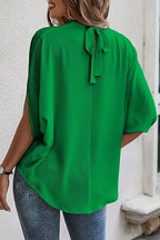 Elegant Trendsi tie-back half-sleeve blouse with side slit, featuring a stylish design and soft fabric, perfect for casual or dressy wear.