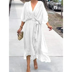Plush Fashion Hub batwing sleeve V-neck midi dress with tied irregular hem, flowing fabric, perfect for stylish, elegant occasions.
