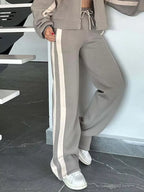 Plus size contrast stripe zip-up activewear jacket and pants set by Plush Fashion Hub, featuring bold stripe details and comfortable fit.
