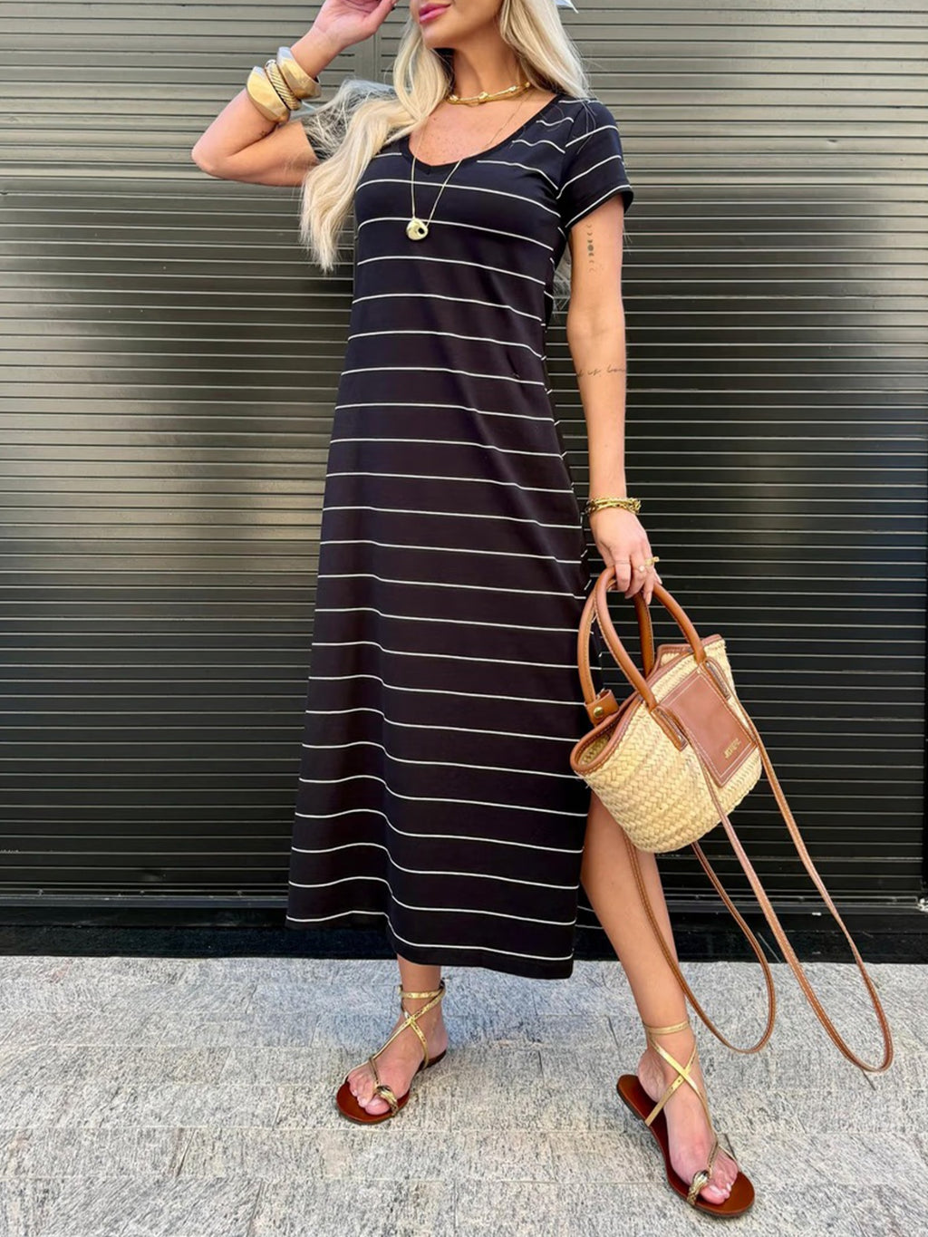 Women's striped side slit cotton midi T-shirt dress by Trendsi, showing a casual fit with horizontal stripes and a side slit detail.