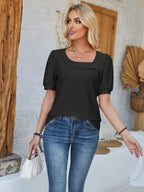 Black eyelet asymmetrical neckline short sleeve T-shirt by Trendsi, featuring a stylish asymmetrical design and eyelet detailing.