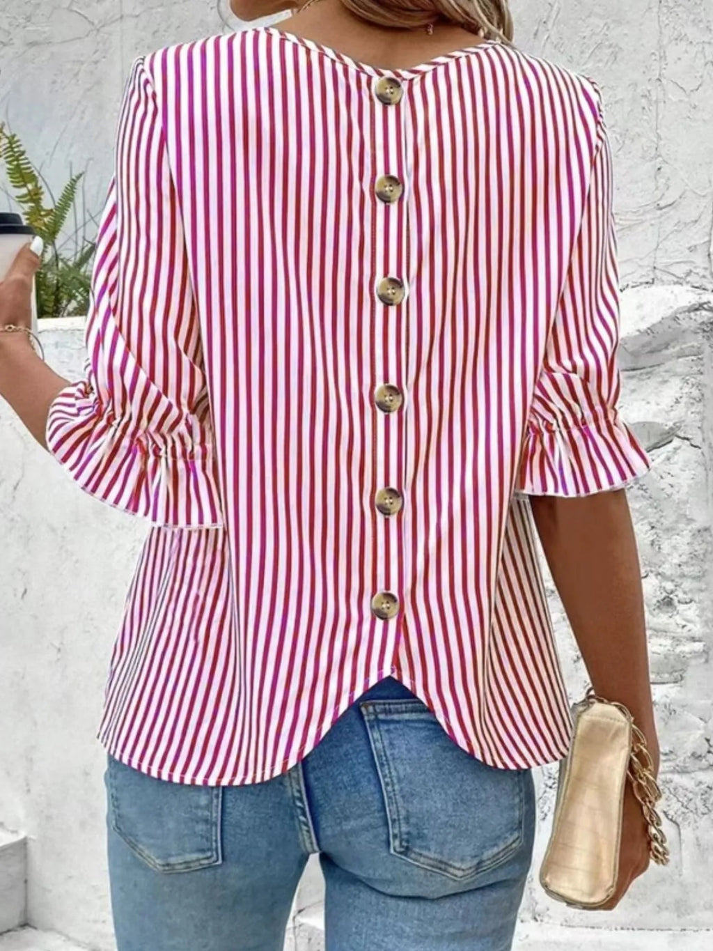 Women's striped ruffled round neck half sleeve blouse from Trendsi, featuring a stylish design with ruffles and a classic round neckline.