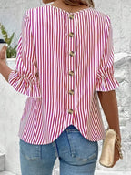 Women's striped ruffled round neck half sleeve blouse from Trendsi, featuring a stylish design with ruffles and a classic round neckline.