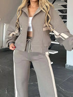 Plus size contrast stripe zip-up activewear jacket and pants set by Plush Fashion Hub, featuring bold color blocking and comfortable fit.