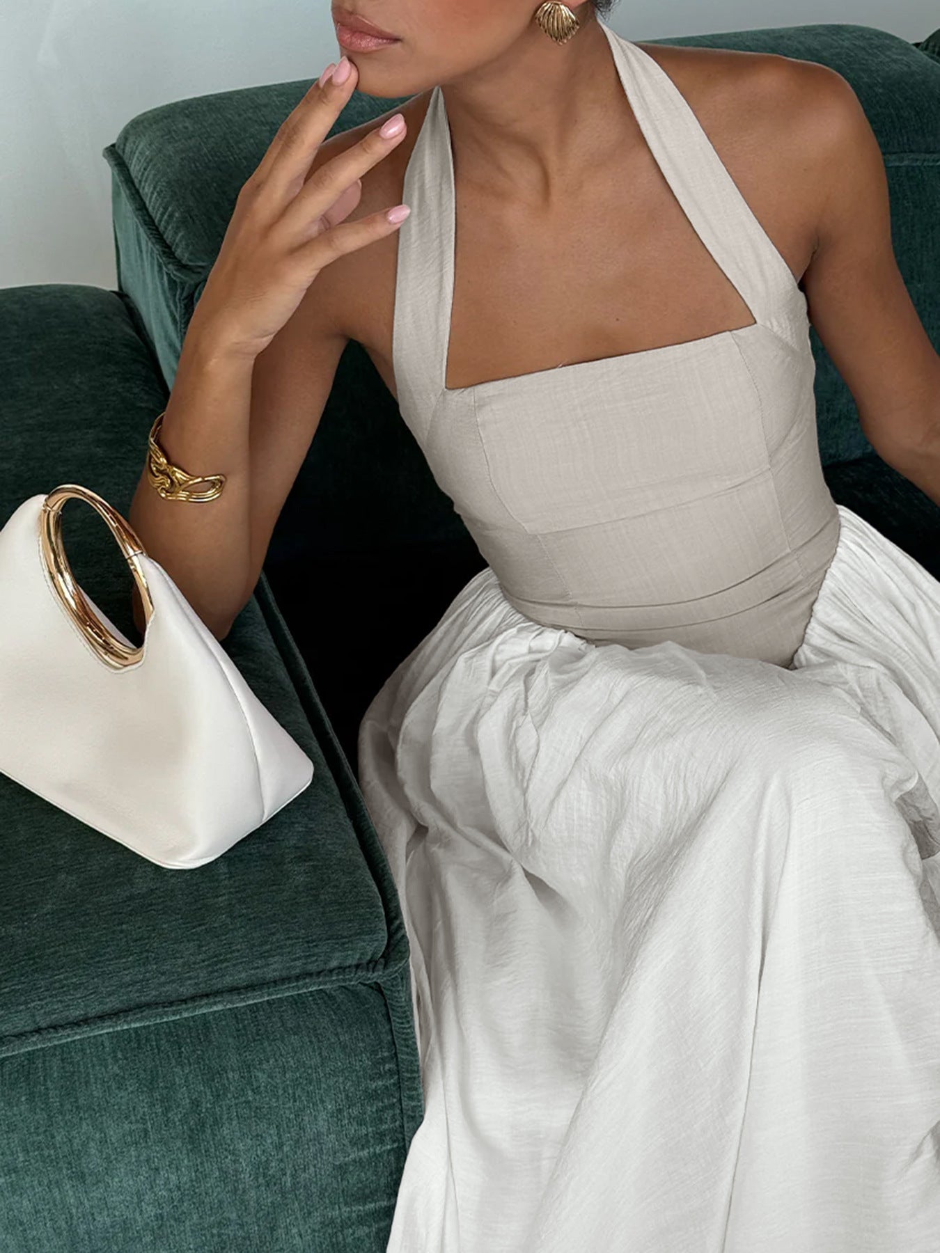 Elegant two-tone halter neck maxi dress with ruched details and pockets, perfect for stylish summer occasions.