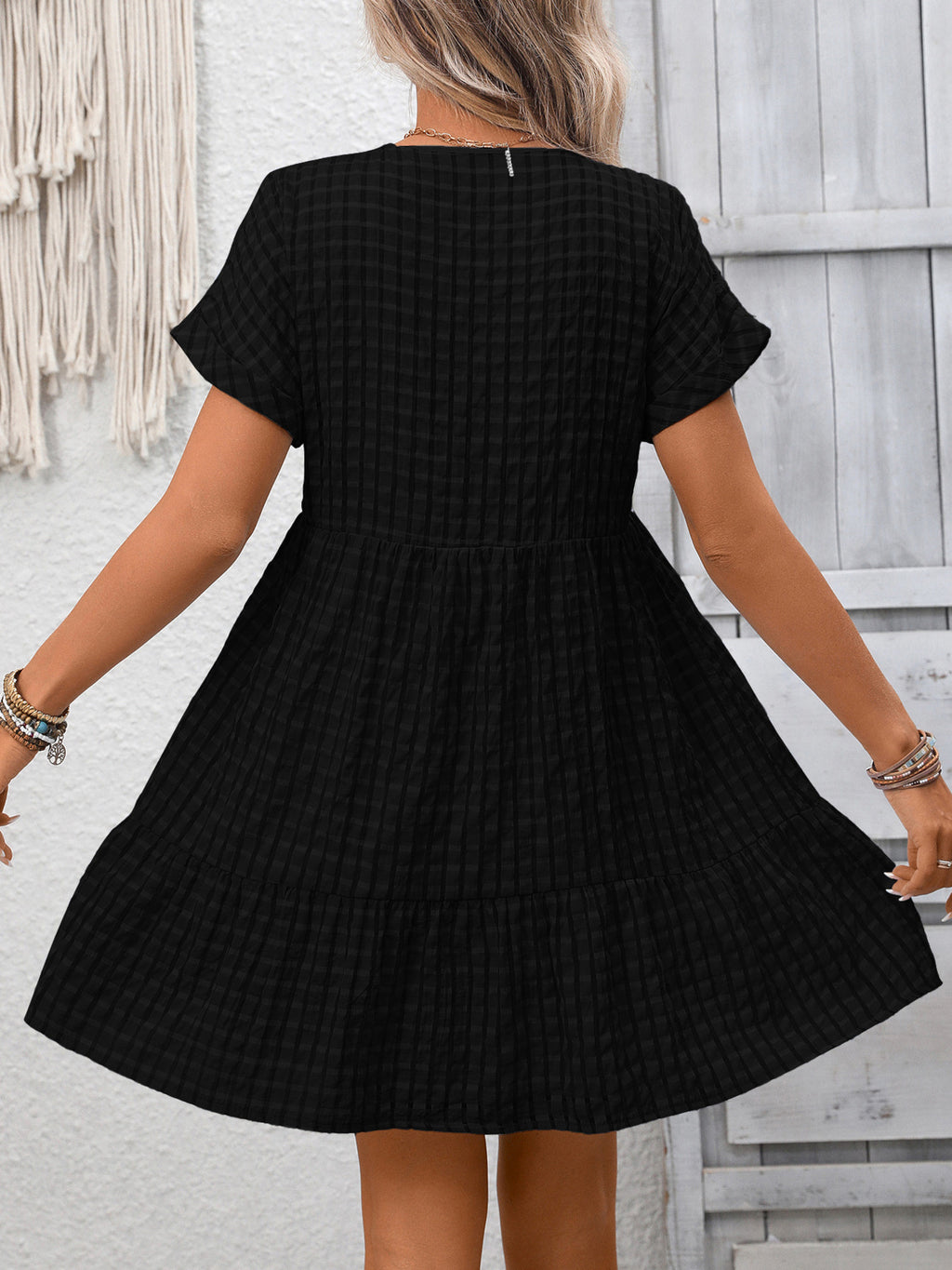 Lightweight plaid V-neck mini dress with ruffle hem from Trendsi, perfect for seasonal fashion and casual occasions.