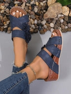 Women's floral crisscross wedge sandals with mid-heel design, featuring colorful flower patterns and comfortable summer shoe style.