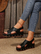 Women's studded PU leather wedge sandals featuring ankle straps and a comfortable casual summer shoe design.