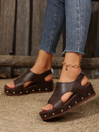 Women's studded PU leather wedge sandals with ankle straps, featuring a comfortable casual design for summer footwear.