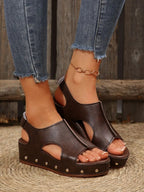 Women's studded PU leather wedge sandals featuring ankle straps and comfortable casual summer style by Trendsi.
