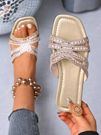 Rhinestone-embellished faux leather flat sandals from Trendsi, featuring comfortable chic design with sparkling rhinestone details.