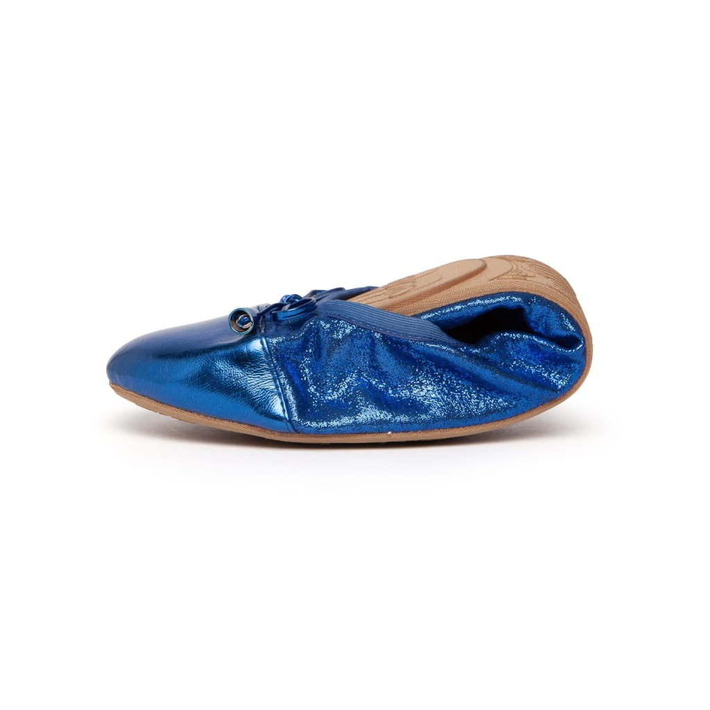 Premium cobalt blue foldable ballet flats in a metallic, shimmery finish with a small front bow and tan sole.