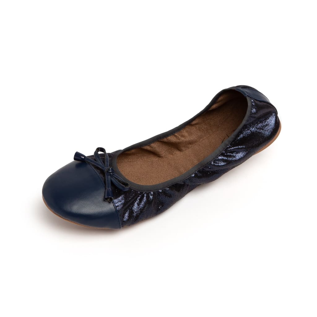 Navy blue ballet flats with a smooth toe cap, a shimmer fabric body, and a decorative bow on a white background.