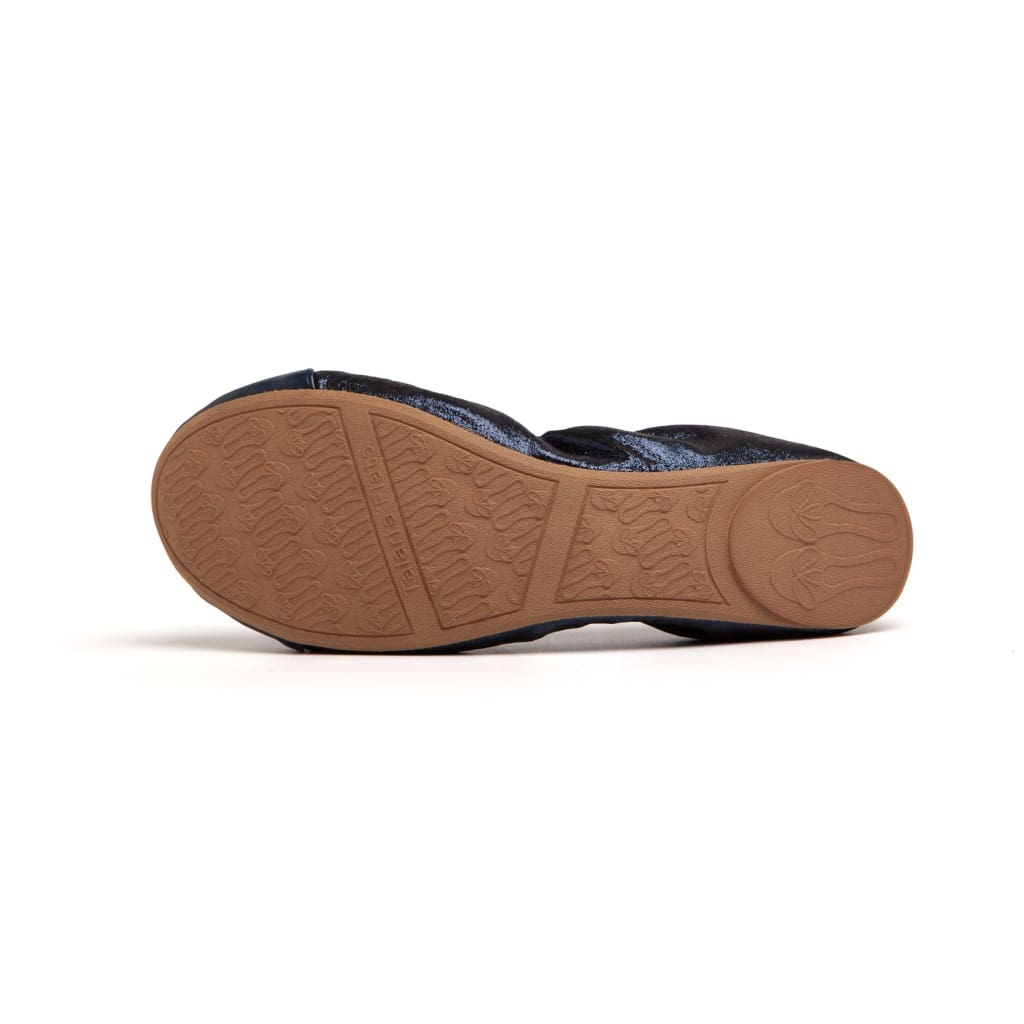 Navy blue glitter ballet flat shown from the sole, featuring a tan rubber grip with embossed logo branding.