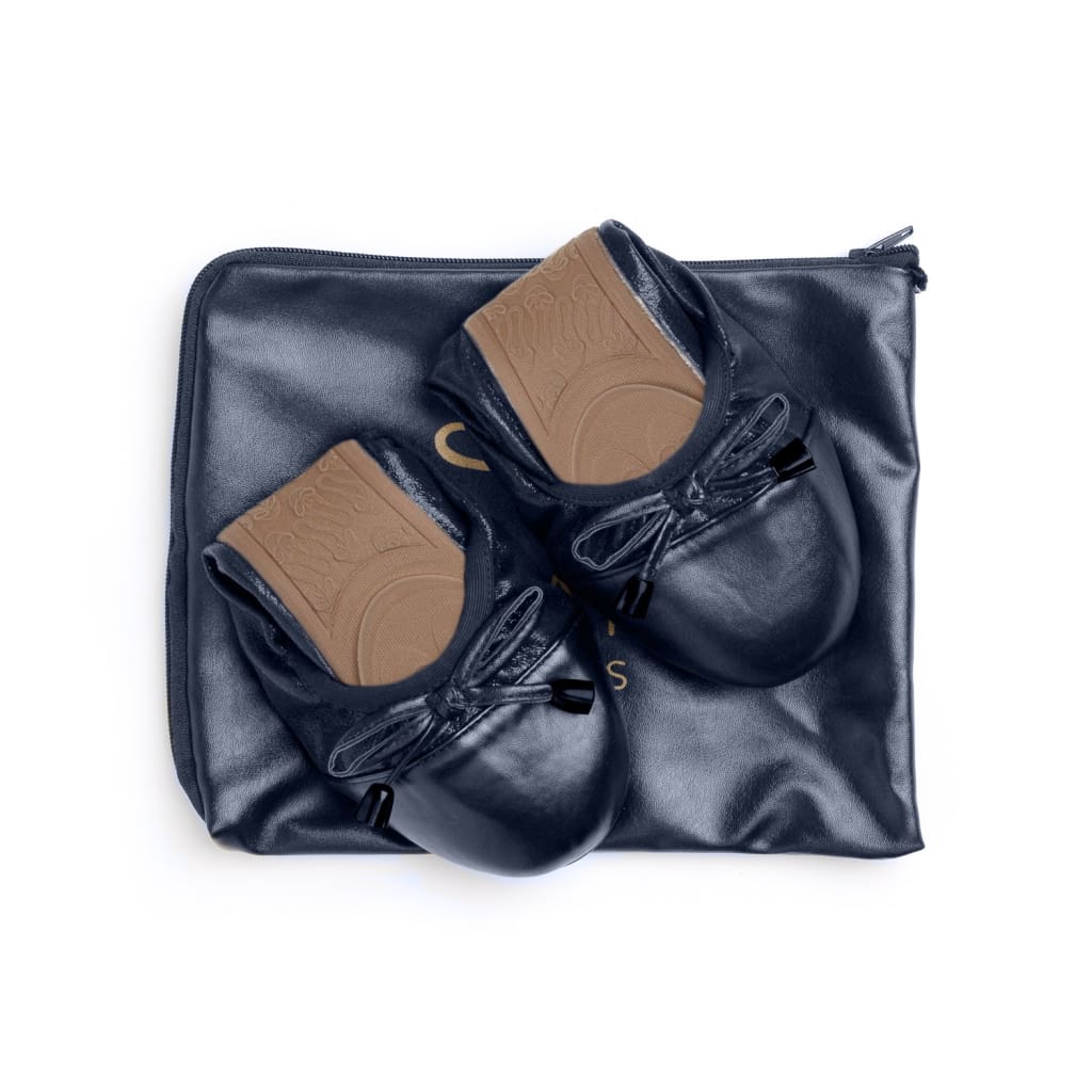Premium navy blue foldable ballet flats with front bows, displayed on a matching navy storage pouch.