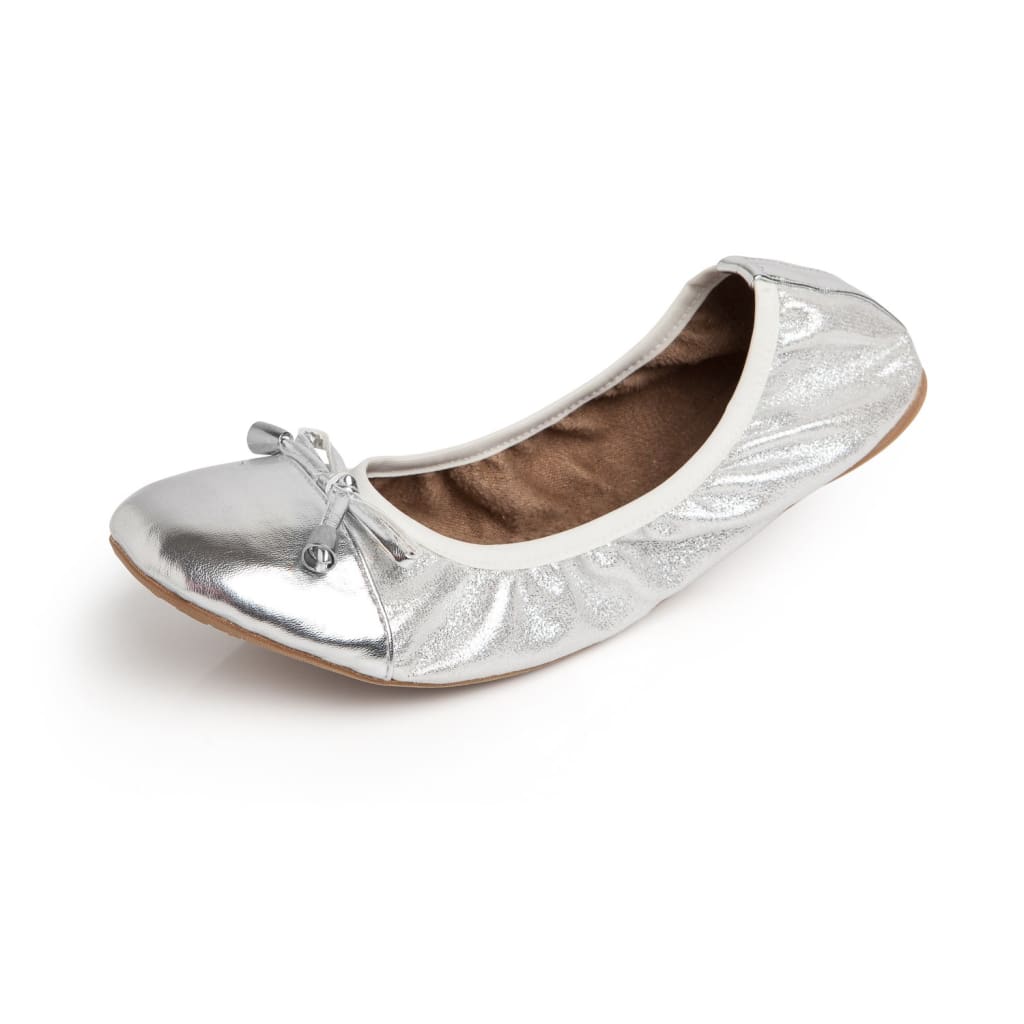 Metallic silver ballet flat with a soft ruched finish, white trim, and a small decorative bow on the round toe.