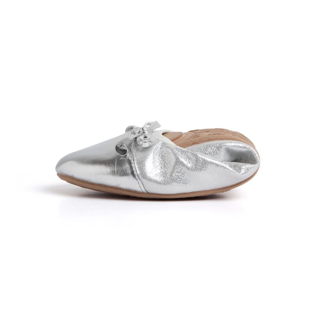 A pair of foldable metallic silver ballet flats with a front bow detail and a tan sole against a white background.