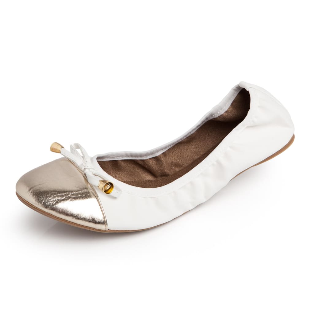 White ballet flat with a metallic gold toe cap and a dainty bow detail, set against a plain white background.