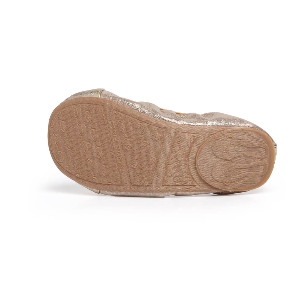 Metallic gold Talaria Littles ballet flat shown from the bottom, highlighting the branded, textured rubber sole.