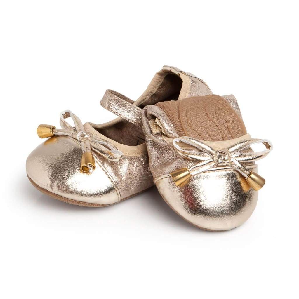 Metallic gold Talaria Littles ballet flats with a Mary Jane strap and bow detail featuring gold bell charms.