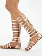 Women's strappy flat sandals with multiple buckles, made from comfortable vegan leather and designed for stylish footwear.