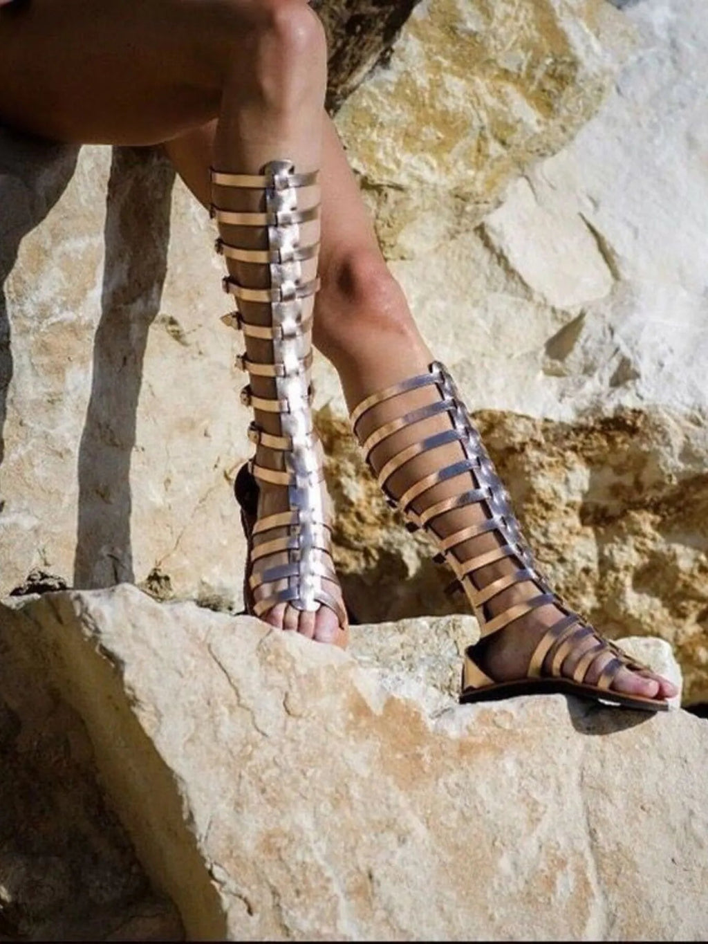 Women's strappy flat sandals with multiple buckles, made from comfortable vegan leather, ideal for casual summer wear.