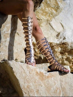 Women's strappy flat sandals with multiple buckles, made from comfortable vegan leather, ideal for casual summer wear.
