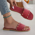 Women's chic studded open toe flat sandals made of vegan leather, featuring a stylish design and comfortable fit.