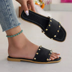 Women's chic studded open toe flat sandals made of vegan leather, featuring comfortable flat design and stylish detailing.