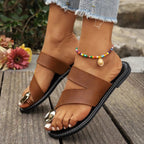 Women's minimalist PU leather toe loop flat sandals by Trendsi, featuring comfortable summer shoe design with sleek style.