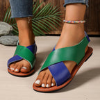 Women's two-tone crisscross strap flat sandals with stylish design, perfect for casual summer footwear.